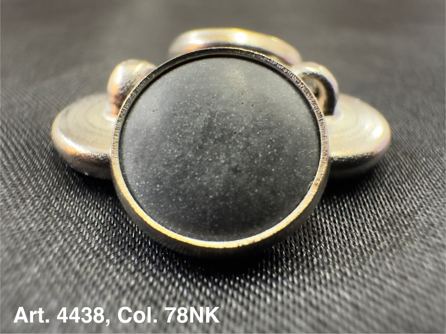 Buttonology Inc polyester garment shank round metal shank button with black center on textured fabric