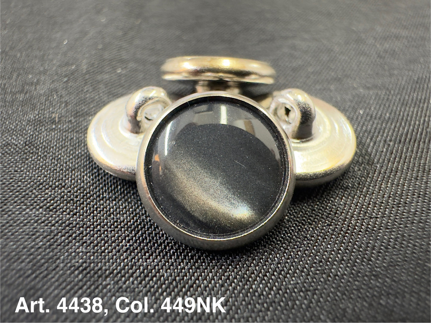 Buttonology Inc polyester garment shank black domed metal shank buttons arranged on textured black fabric