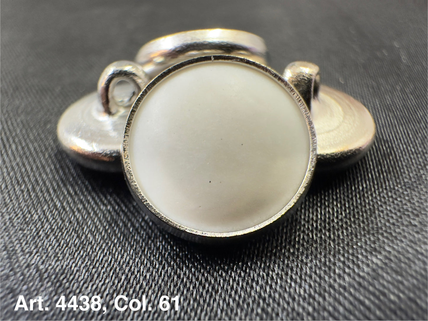 Buttonology Inc silver rim button shank with white center close up polyester garment shank for tailored coats