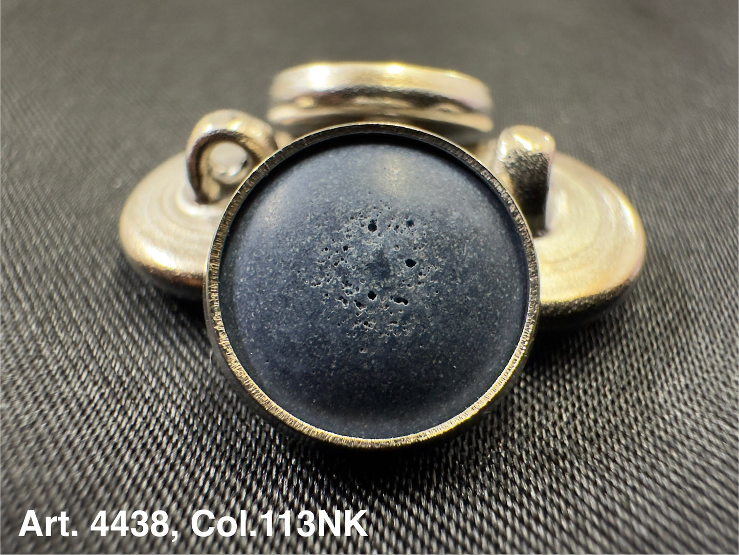 Buttonology Inc metal button shank with textured black enamel center on black fabric polyester garment shank
