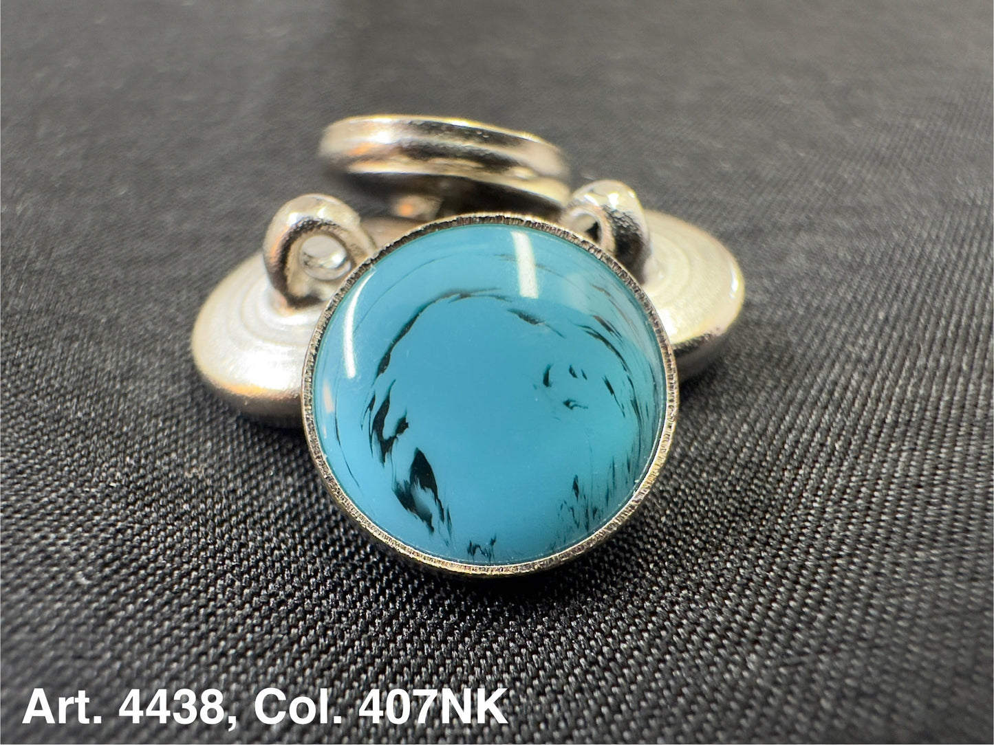 Buttonology Inc polyester garment shank turquoise cabochon set in silver metal decorative shank button on black fabric