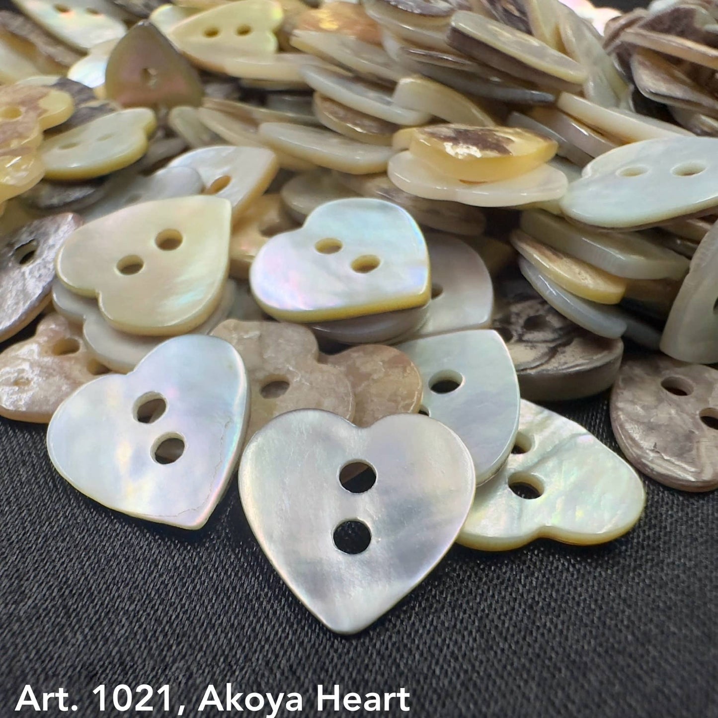 Akoya heart buttons by Buttonology Inc with iridescent finish and two holes for sewing