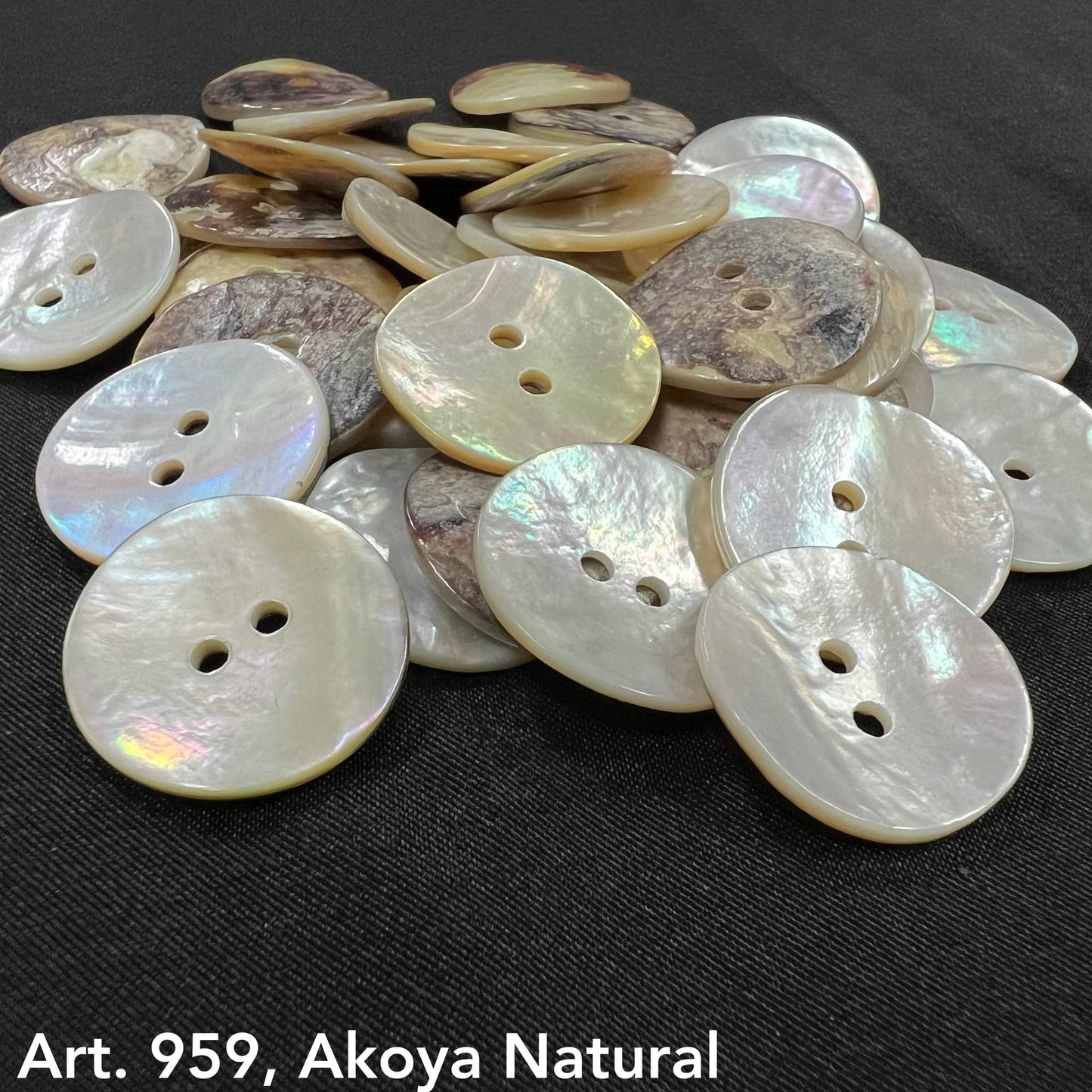 Super thick shell buttons by Buttonology Inc in natural Akoya style with two holes on black background