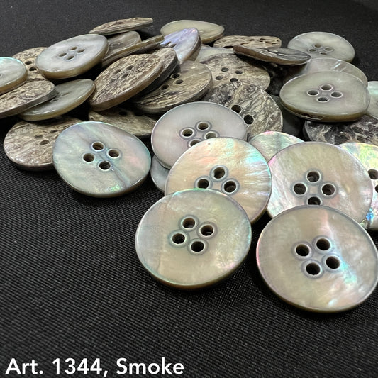 Akoya smoke buttons by Buttonology Inc with a shiny, iridescent finish on a black fabric background