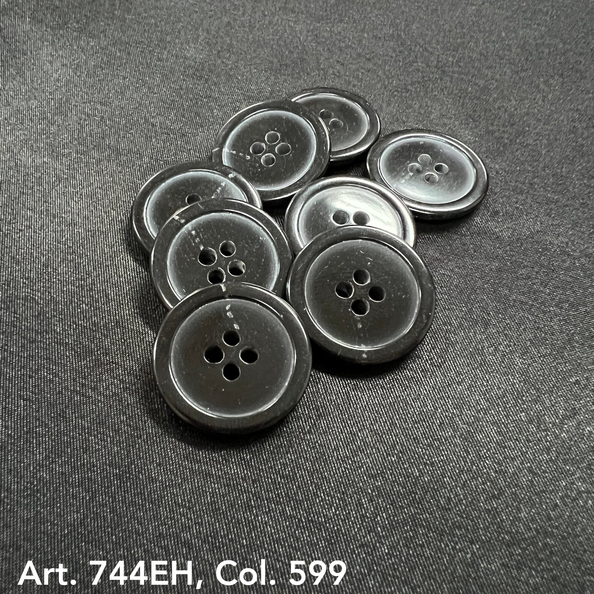 Buttonology Inc fort horn effect four hole buttons glossy charcoal grey pile on black fabric background