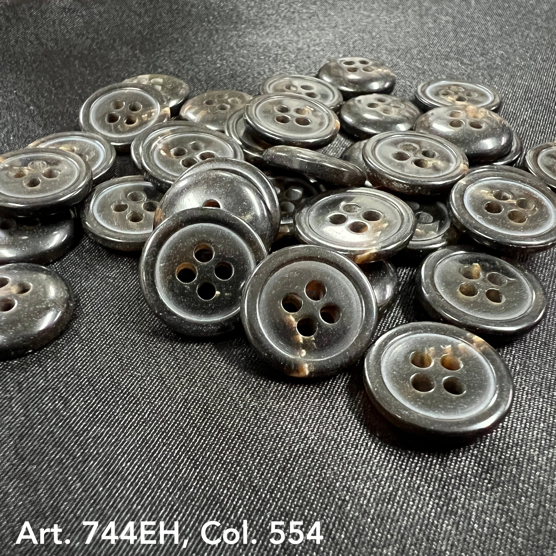 Buttonology Inc fort horn effect four hole buttons glossy dark gray round sew on buttons in a piled display