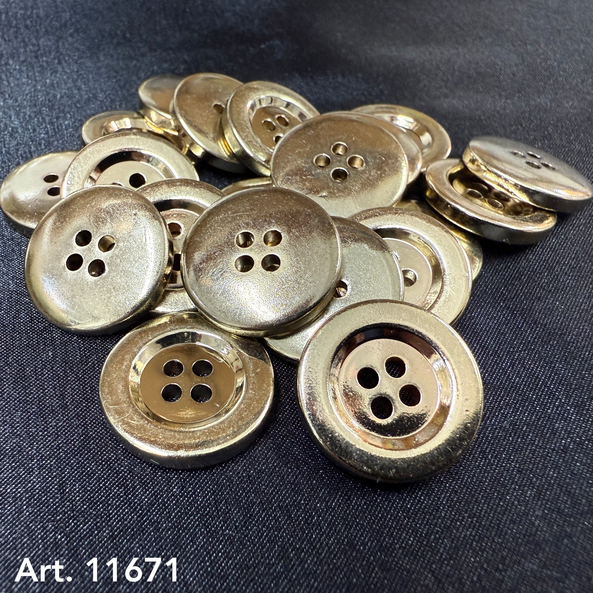 Buttonology Inc Gold Plated Nylon Buttons four hole shiny gold buttons piled on black fabric background