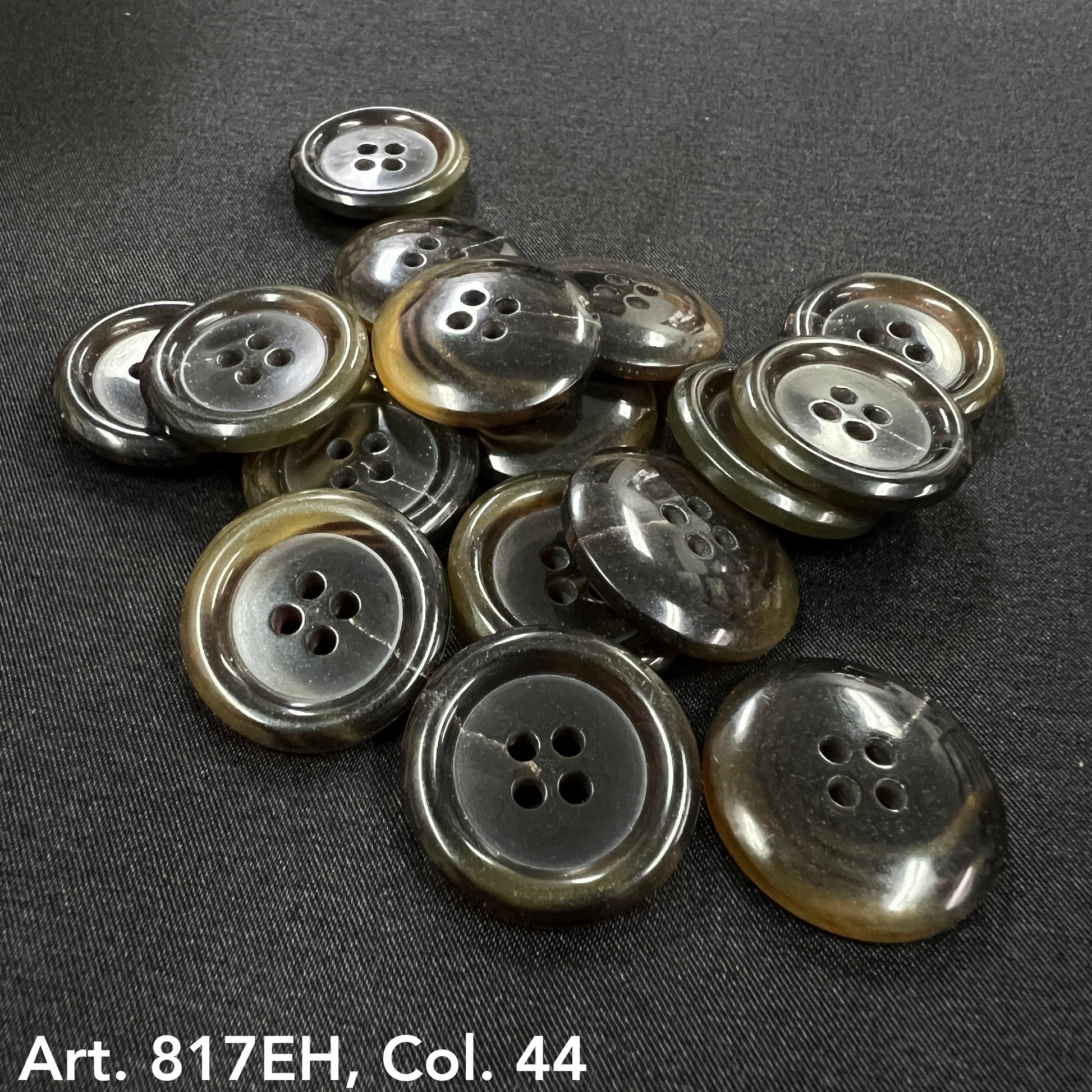 Premium sewing buttons online by Buttonology Inc four-hole round grey and brown buttons on black fabric