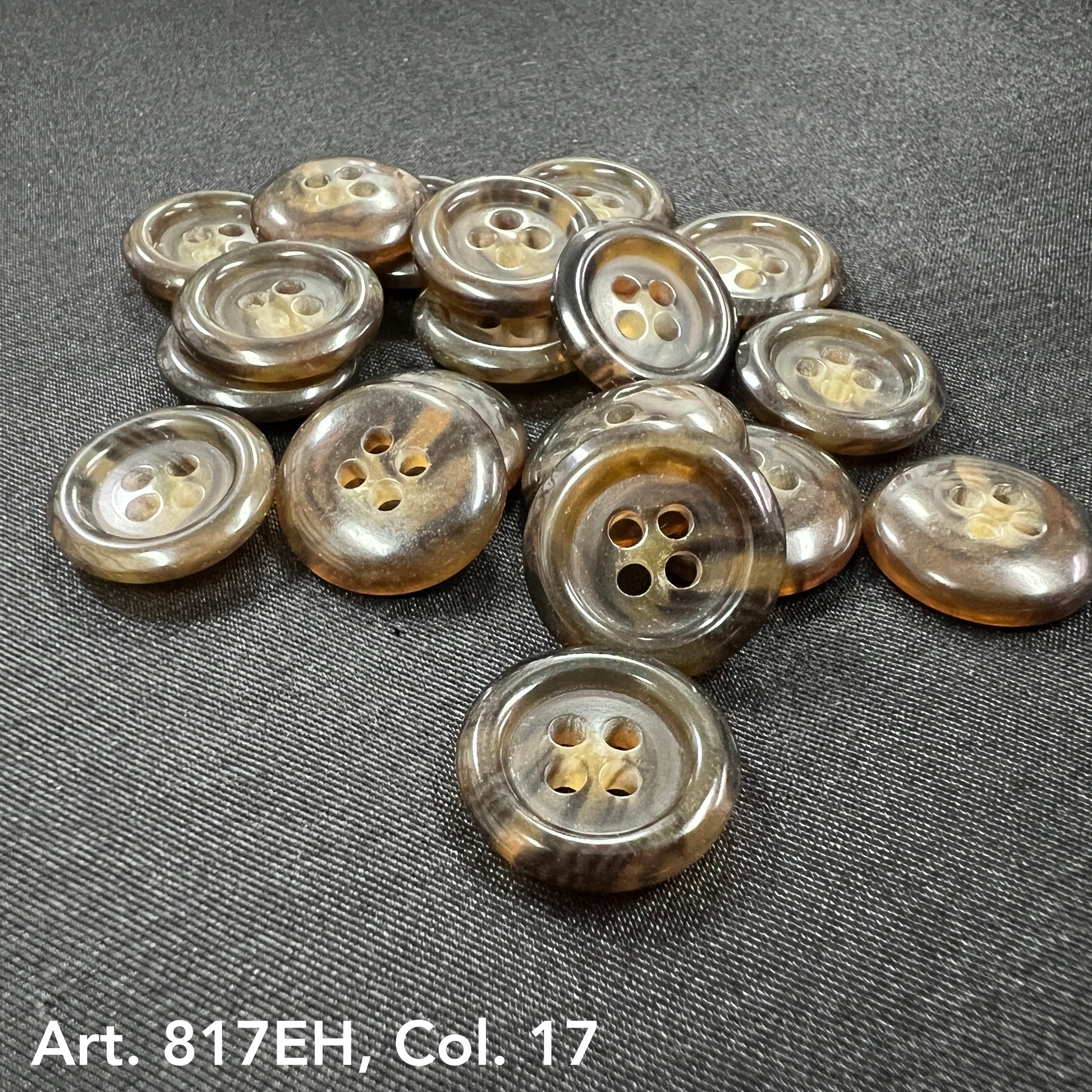 Premium sewing buttons online from Buttonology Inc in various glossy brown shades on dark fabric