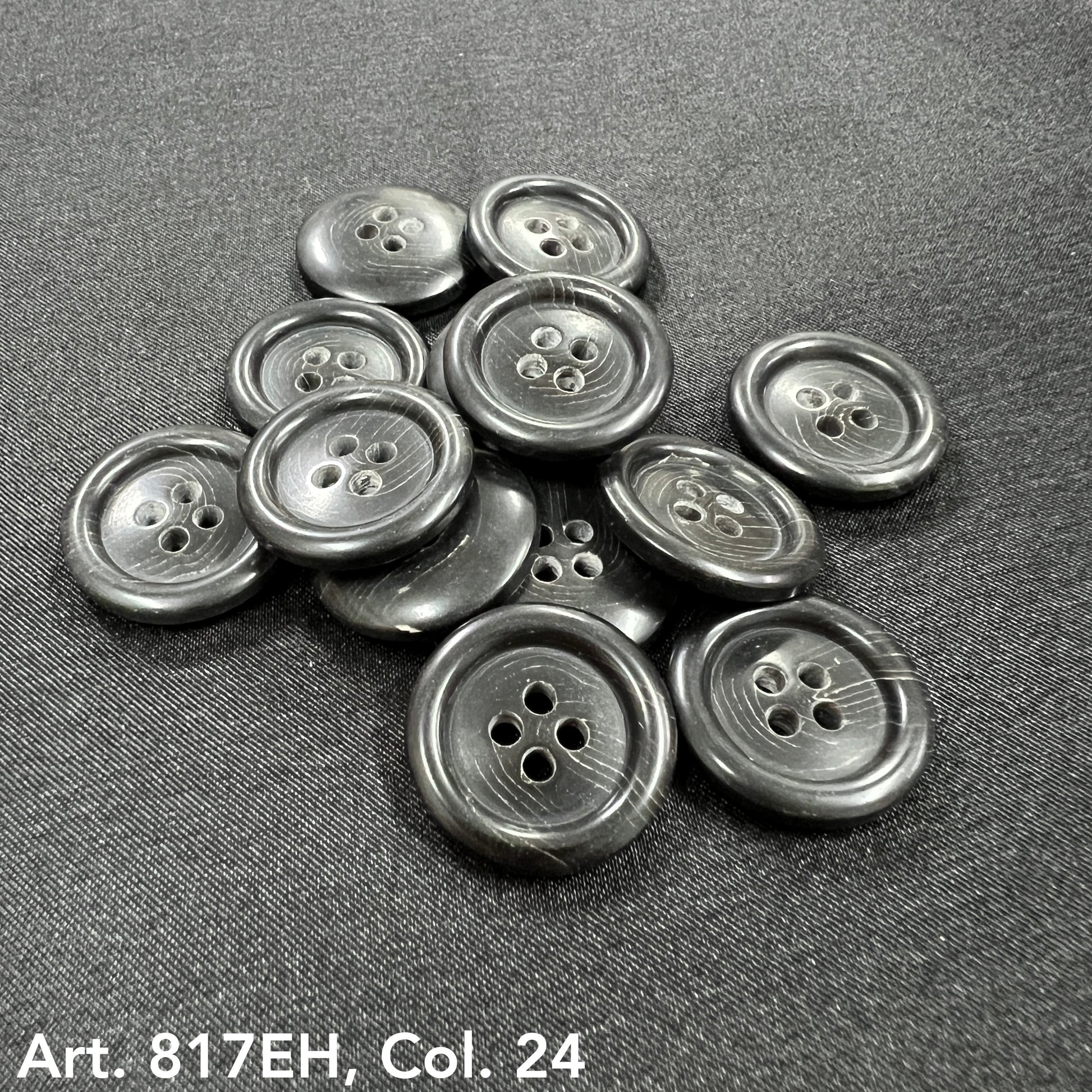 Premium sewing buttons online black four-hole buttons by Buttonology Inc on black fabric