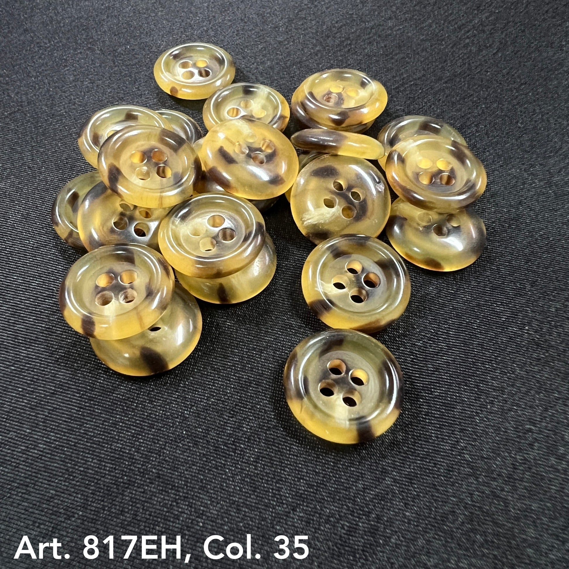Premium sewing buttons online featuring yellow and brown round four-hole buttons on black fabric