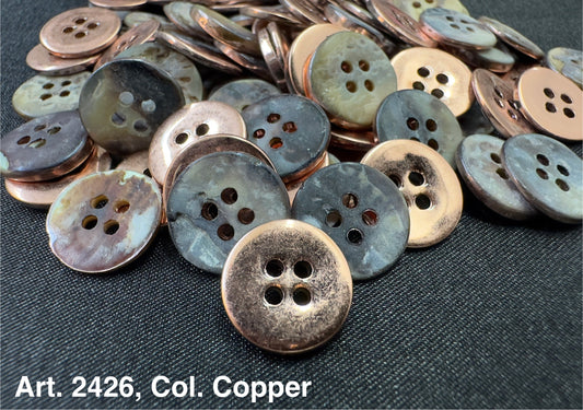 Buttonology Inc copper shell garment buttons four hole aged patina finish on dark woven fabric background