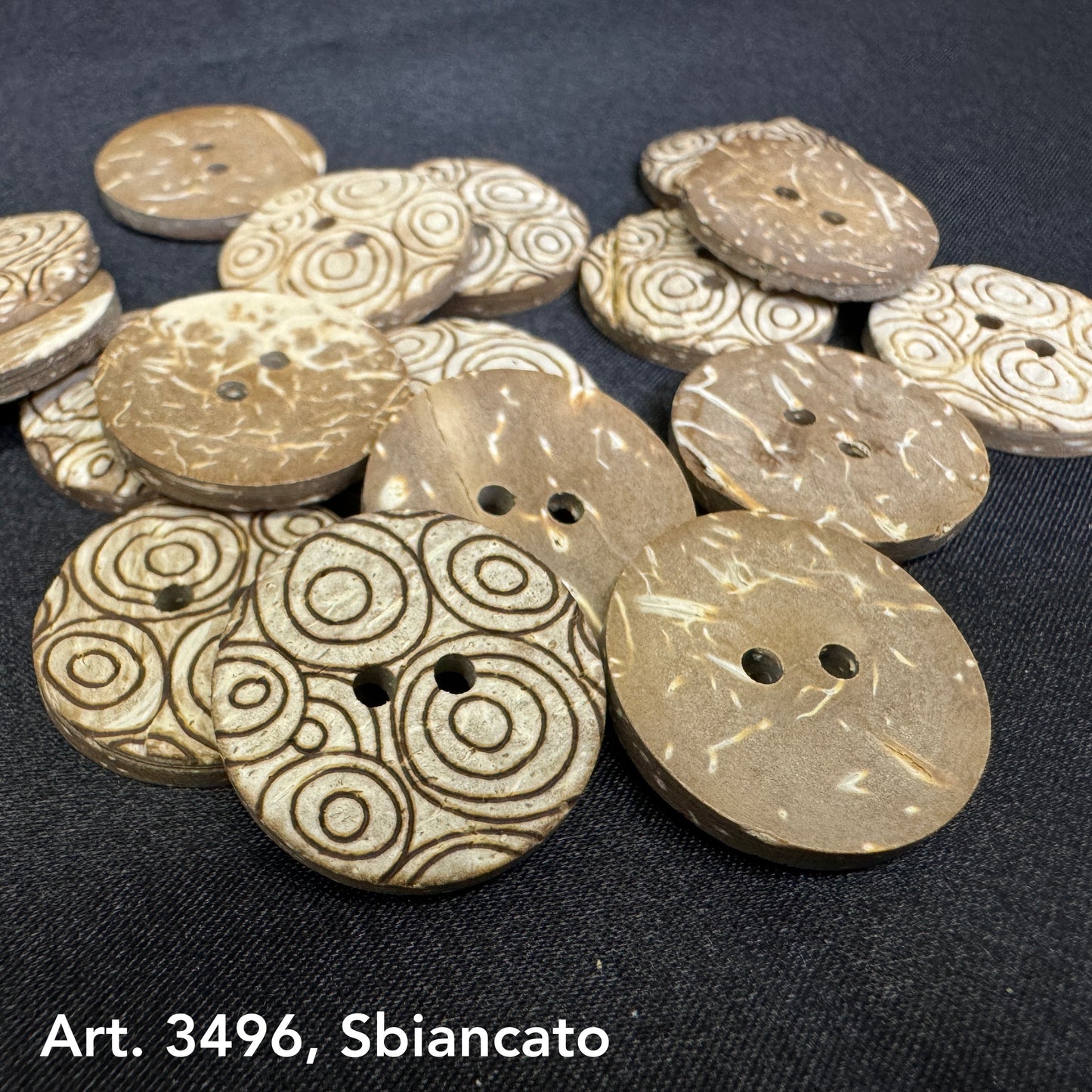 Sustainable coconut buttons by Buttonology Inc with natural tones and circular patterns on black background