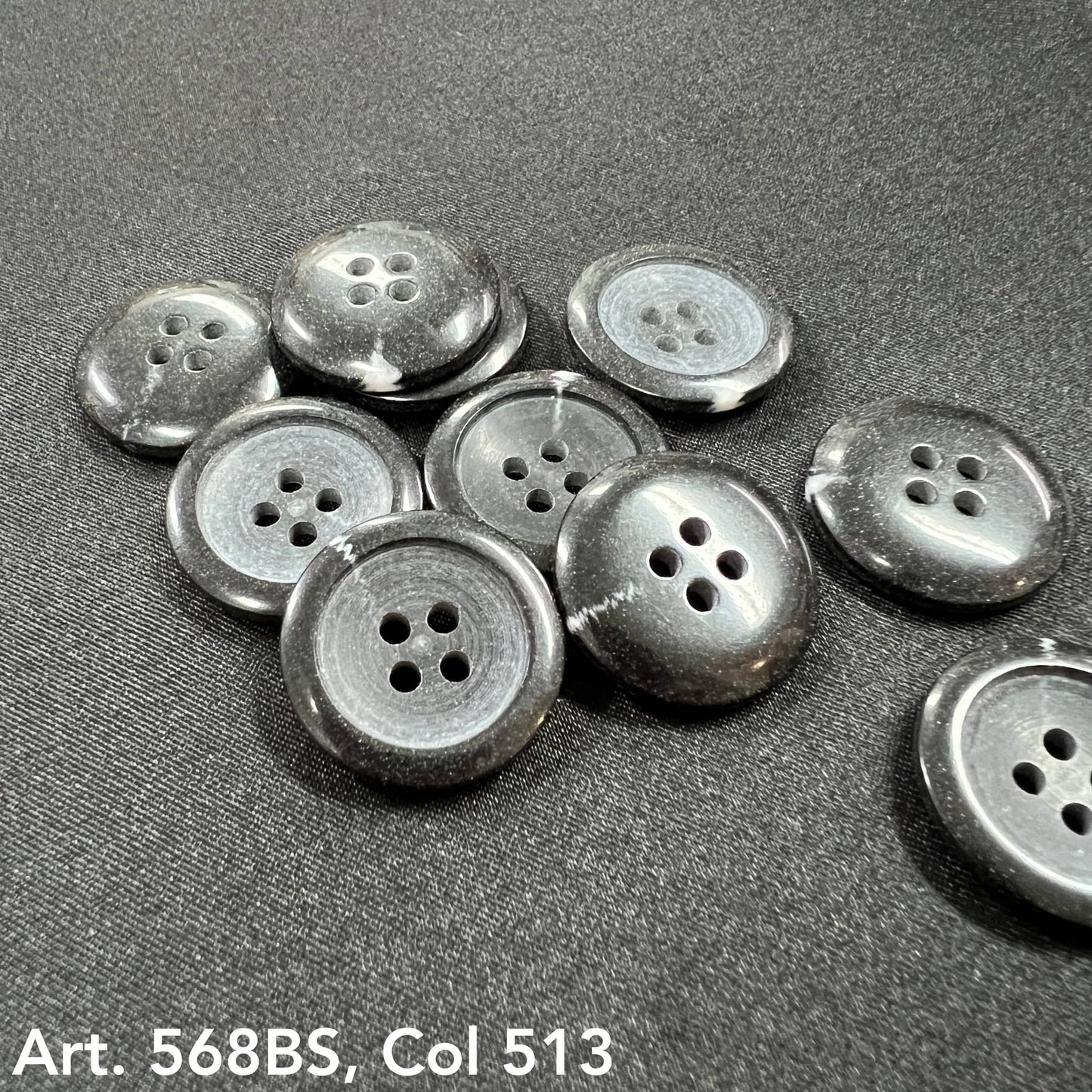 Set of black 4-hole garment buttons in various sizes from Buttonology Inc.