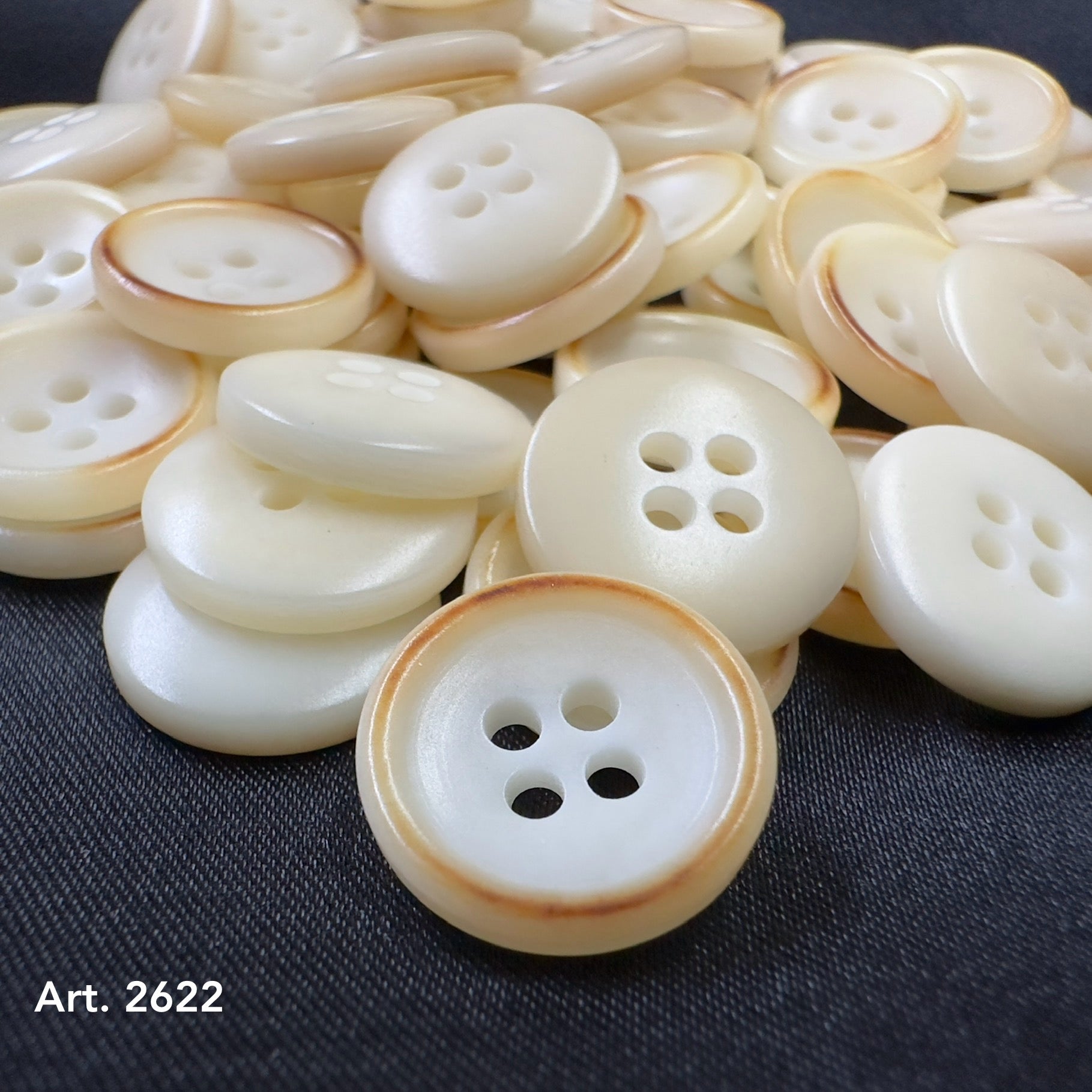 Burnt corozo buttons sustainable fashion by Buttonology Inc in cream with brown edges, eco-friendly and stylish