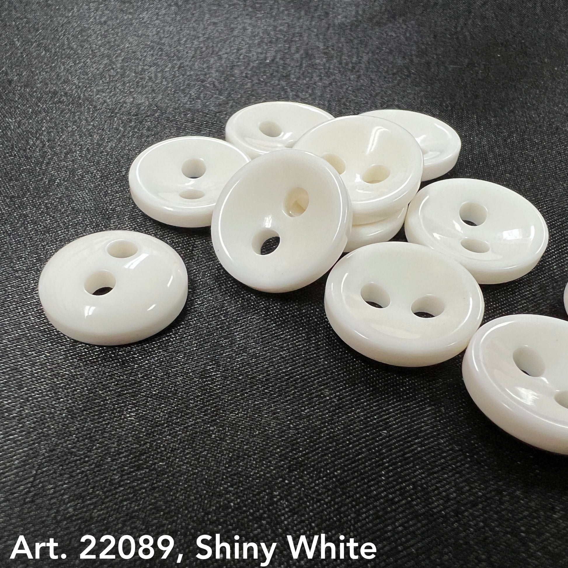 Buttonology Inc shiny white round buttons on black fabric Art 22089 glossy discs buy shiny black buttons online
