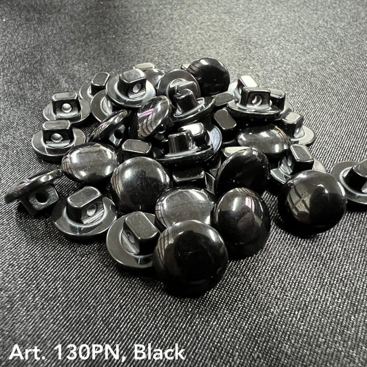 Black buttons sewing supplies by Buttonology Inc. arranged on fabric for craft and garment projects