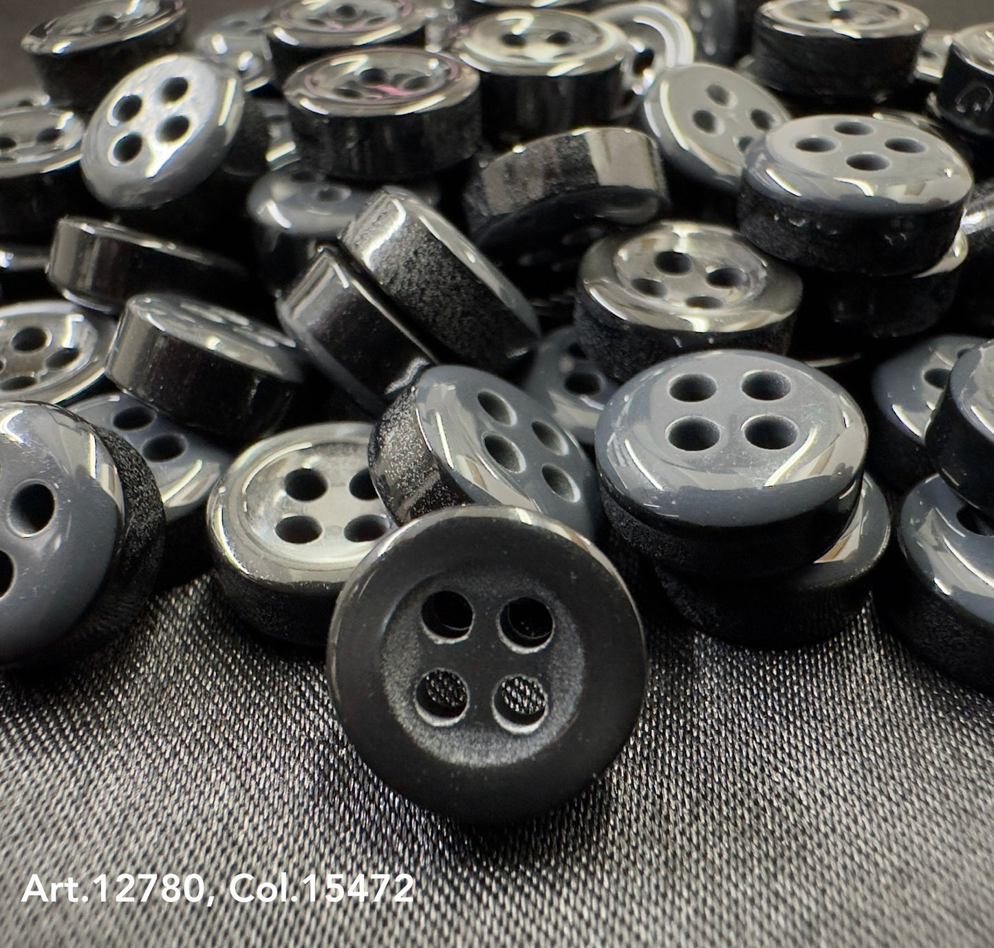Black and gray four-hole buttons close-up from Buttonology quality button supply collection