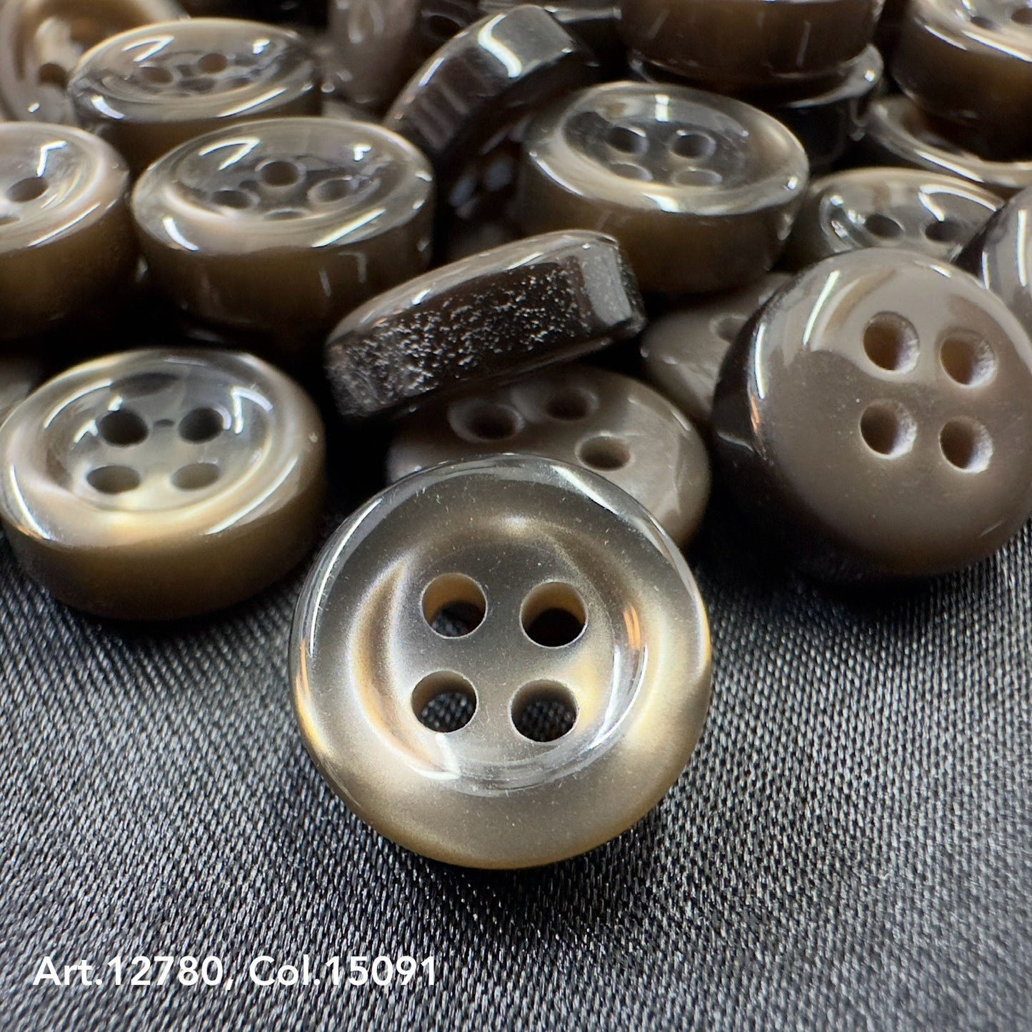 Close-up of brown four-hole buttons providing Buttonology quality button supply for sewing projects