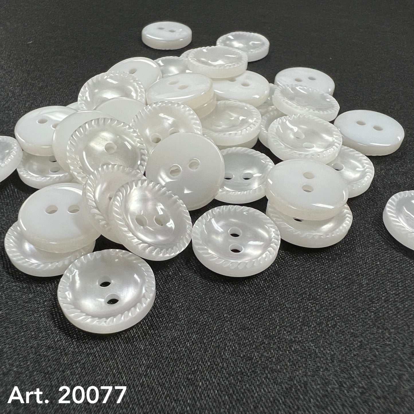 White pearlized two hole buttons with rope edge on dark fabric by Buttonology Inc sew-on buttons for shirts
