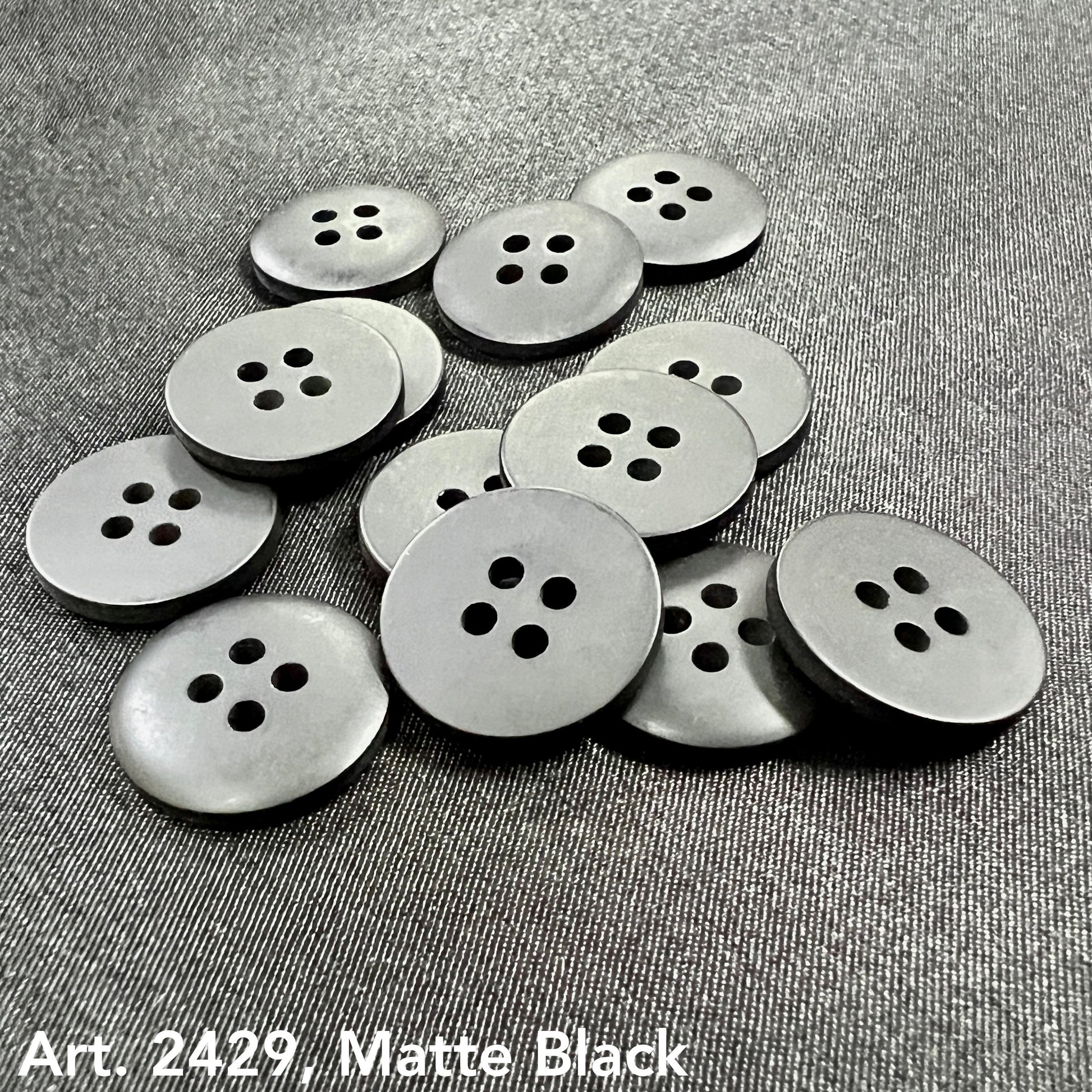 Matte black sewing buttons with four holes from Buttonology Inc to buy sewing buttons online