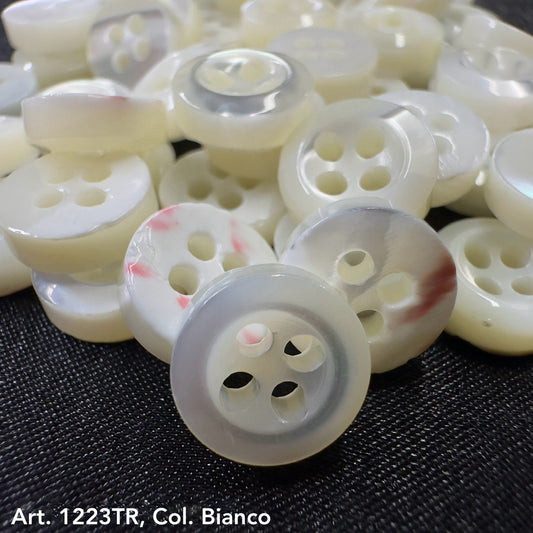 Buy shell buttons online from Buttonology Inc white round four-hole buttons with subtle red accents