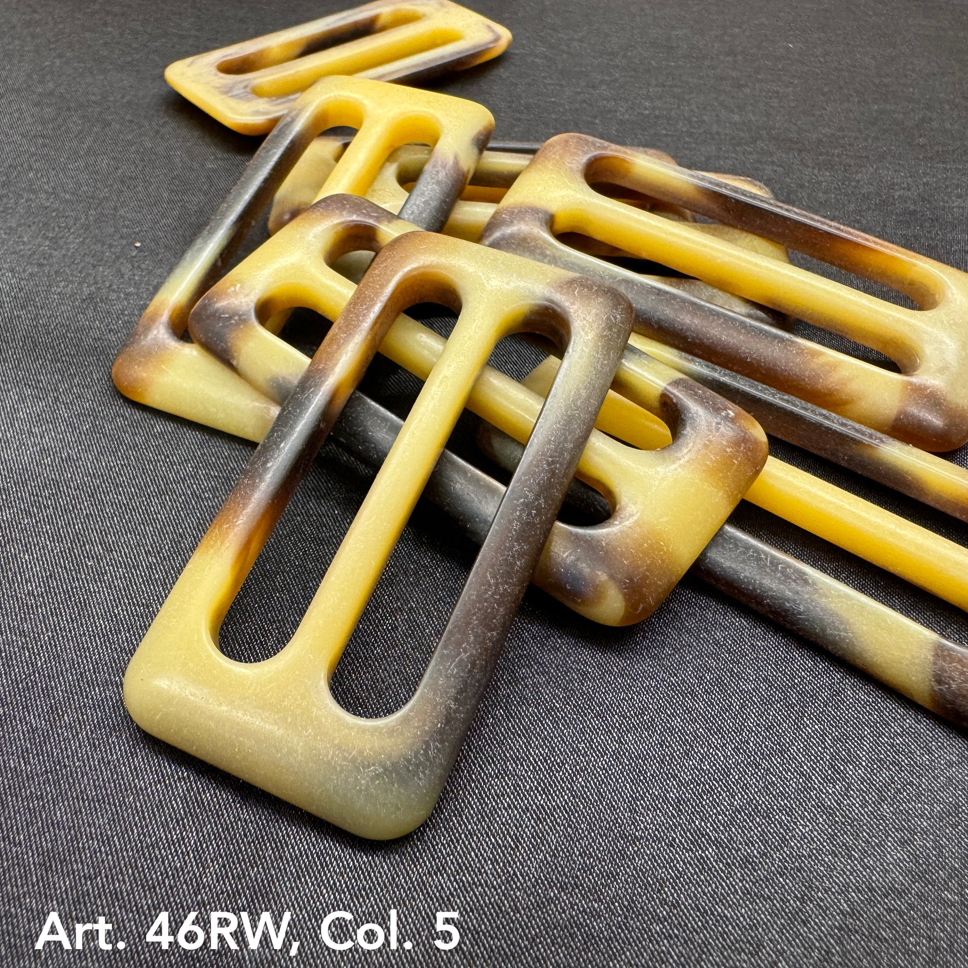 Buttonology Inc decorative belt buckle buttons in brown and yellow gradient on black background