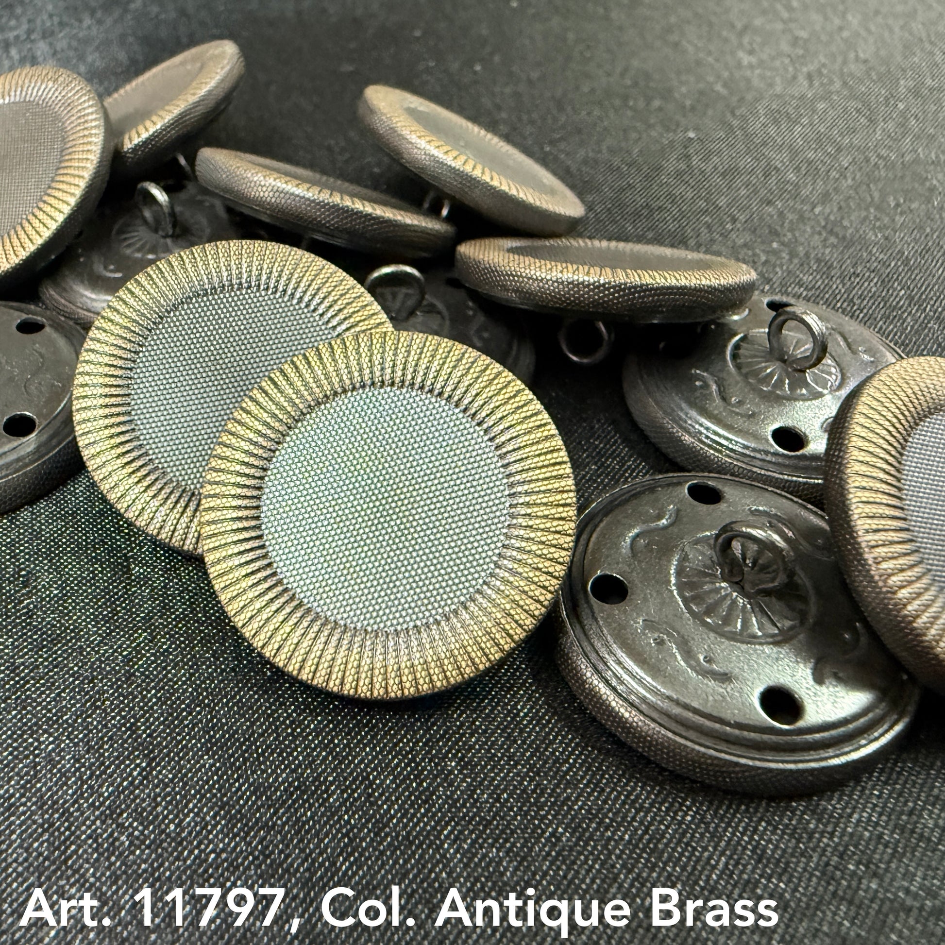 Decorative sewing buttons for coats in antique brass finish by Buttonology Inc with textured edges