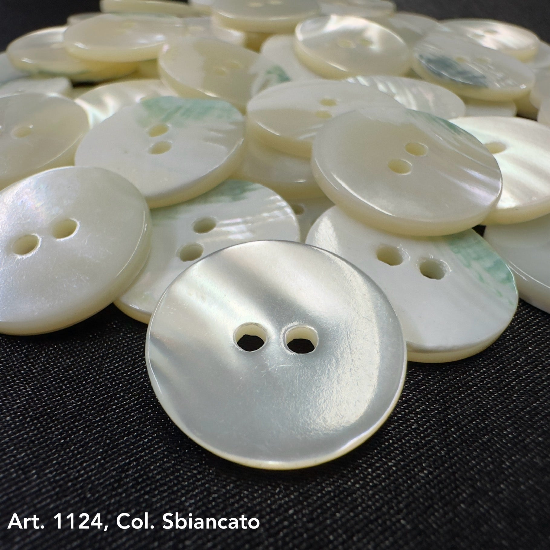 Glossy white shell buttons with two holes for DIY shell button projects by Buttonology Inc