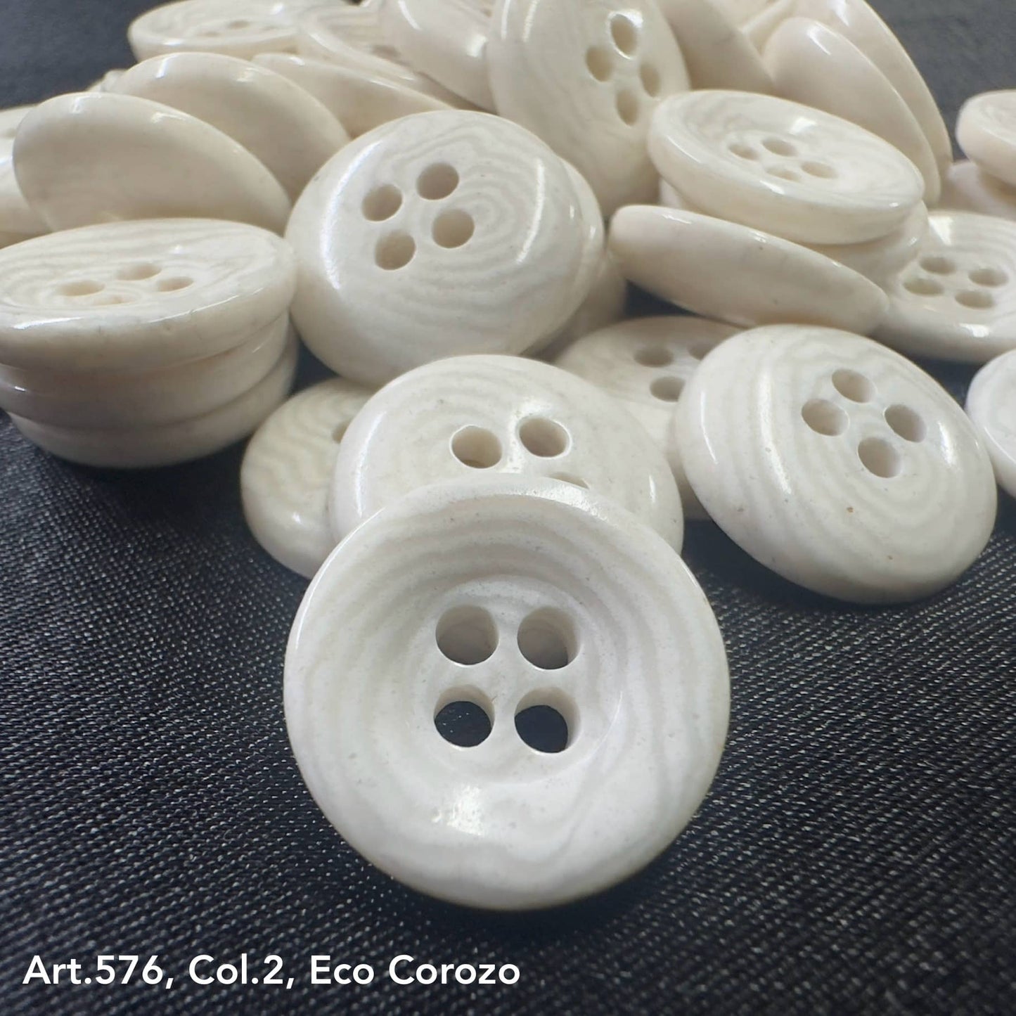 Natural eco corozo buttons with a smooth finish and four holes for sewing projects
