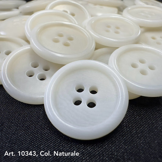 Close-up of white eco-friendly clothing buttons with four holes on black fabric background