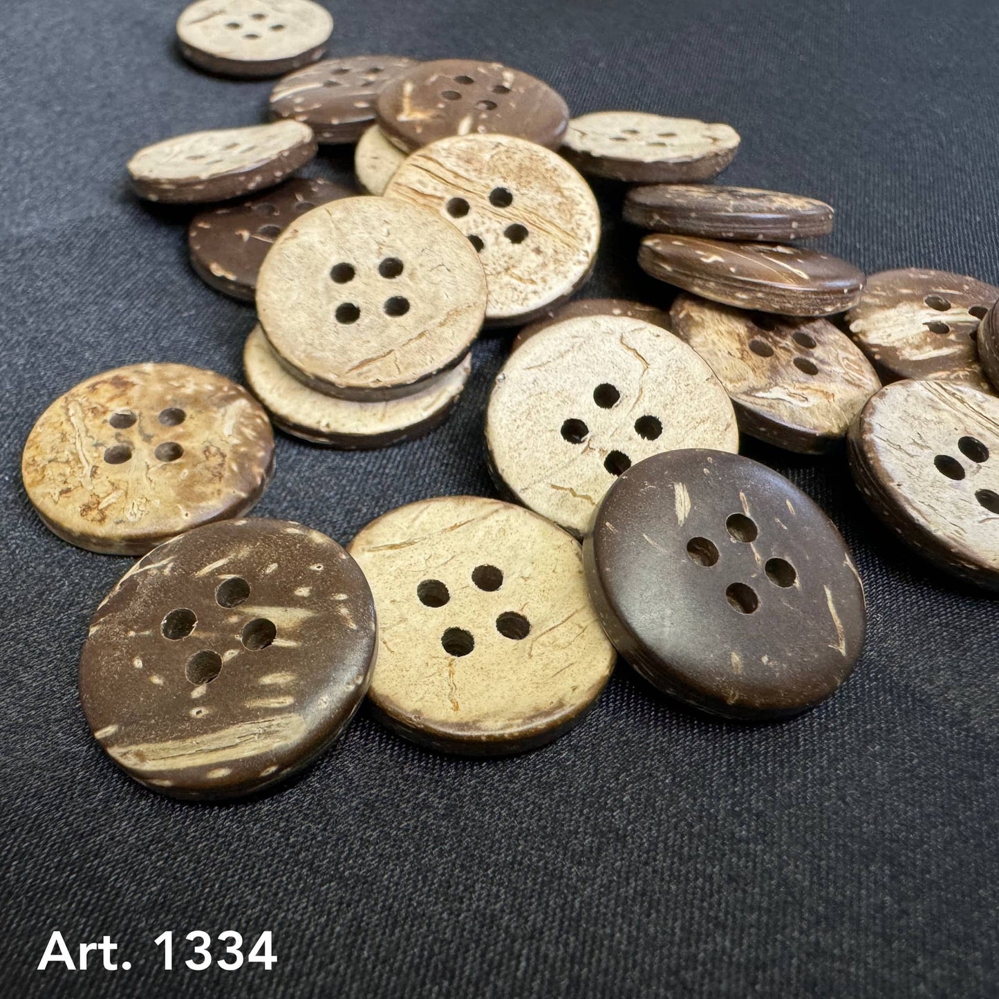 Eco-friendly coconut buttons by Buttonology Inc in natural brown and beige tones with four holes each