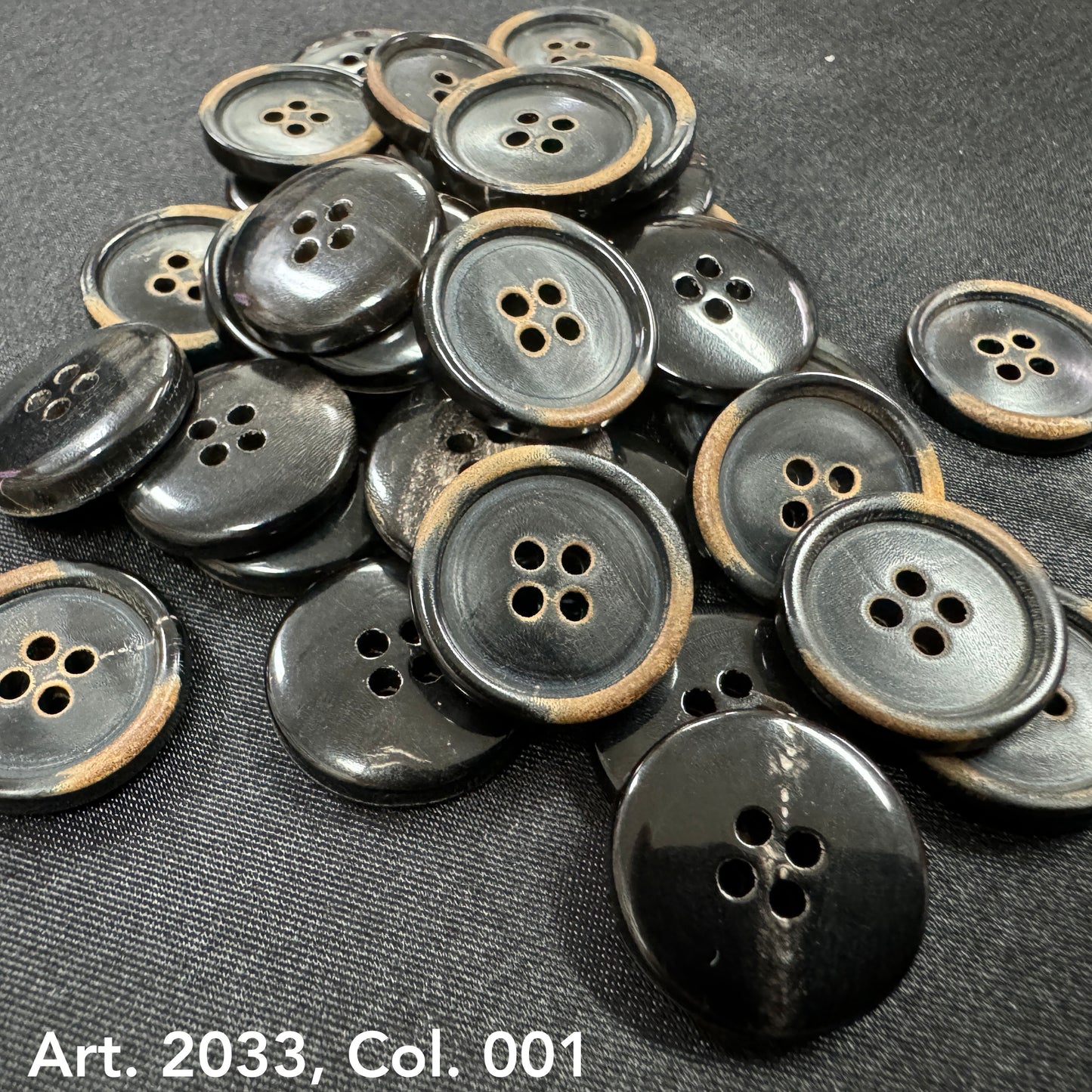 Eco-friendly horn buttons by Buttonology Inc with a black and natural brown edge design