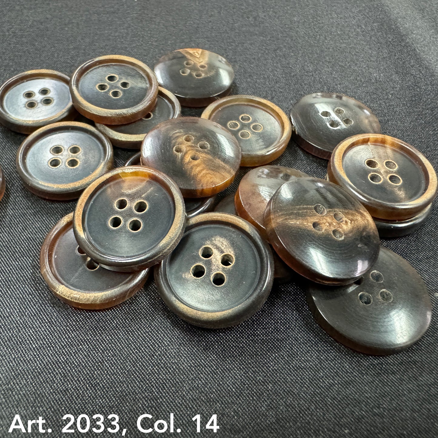 Eco-friendly horn buttons by Buttonology Inc in natural brown and black shades with four holes