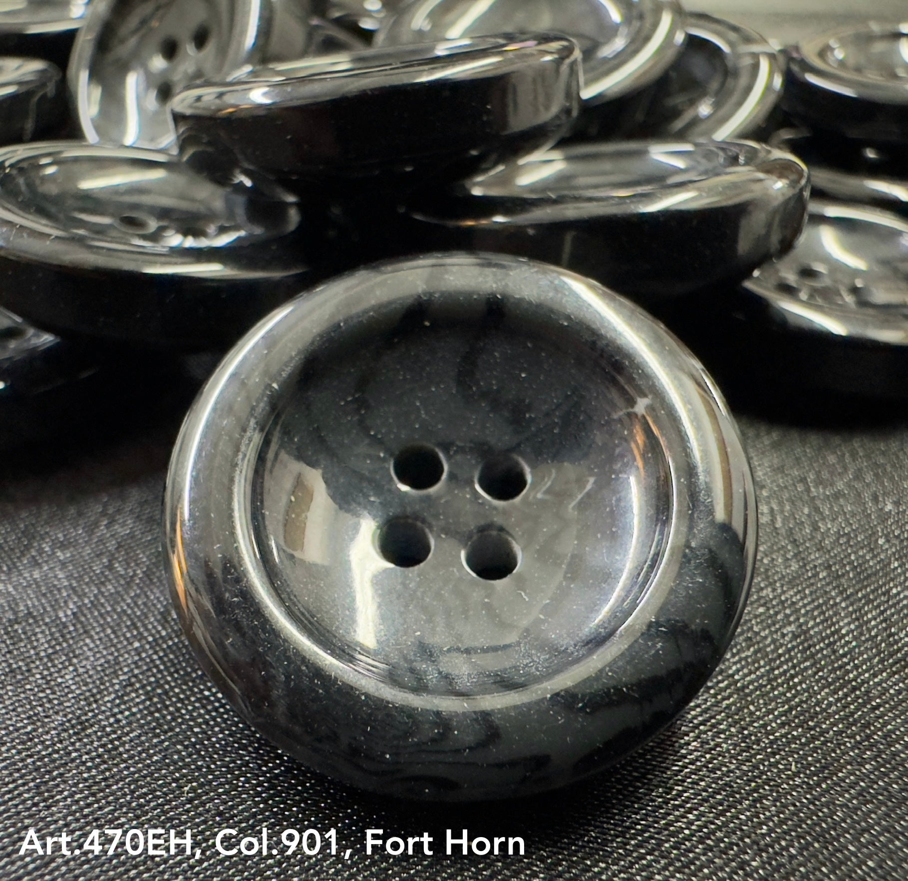 High-quality garment buttons in black with four holes for secure fastening and elegant style