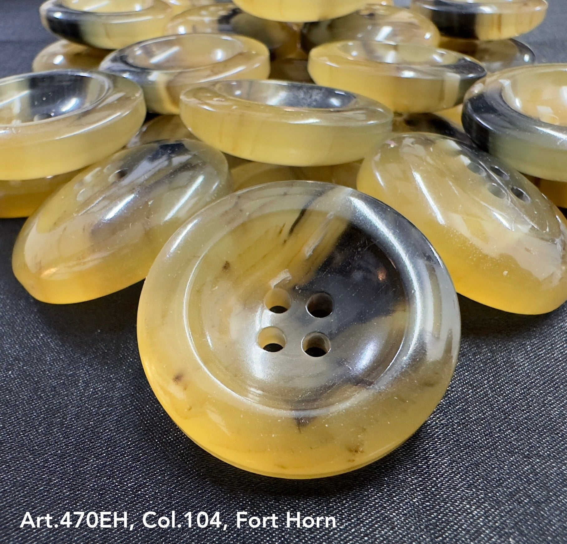 High-quality garment buttons in yellow and black, featuring a smooth finish and four holes for easy sewing