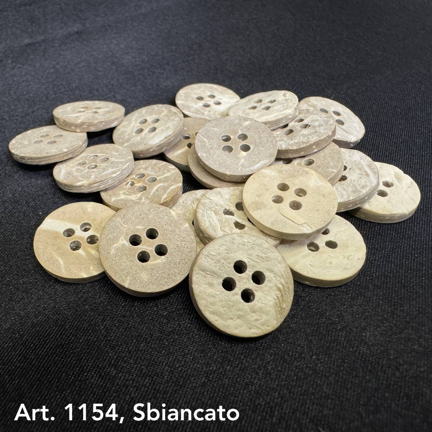 Coconut buttons for sewing by Buttonology Inc with four holes and natural textured finish