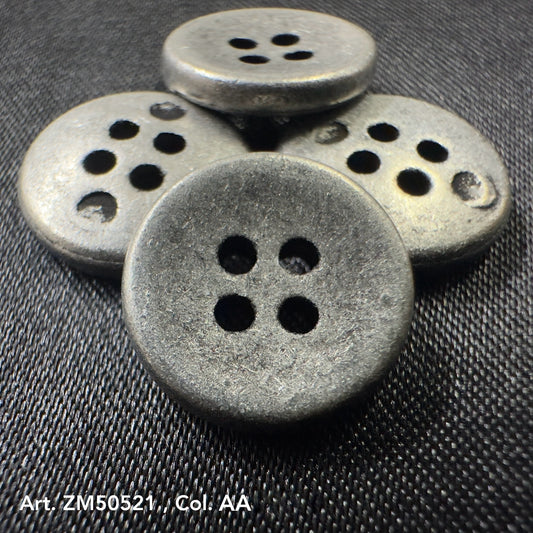 Set of four round metal buttons for clothes with a matte finish and four holes on dark fabric