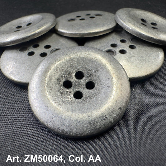 Rustic silver metal buttons for clothing with four holes displayed on black fabric