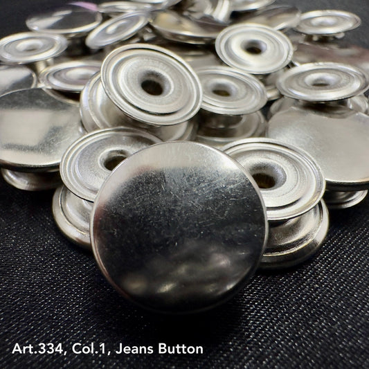 Shiny metal jean buttons for sewing displayed in a pile, ideal for DIY fashion projects