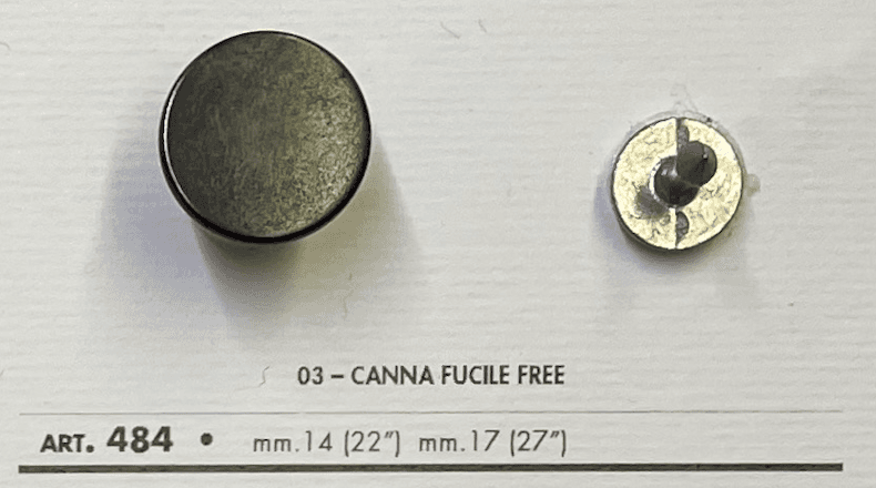 Metal jeans button for sewing in black, featuring a smooth surface and attached prong