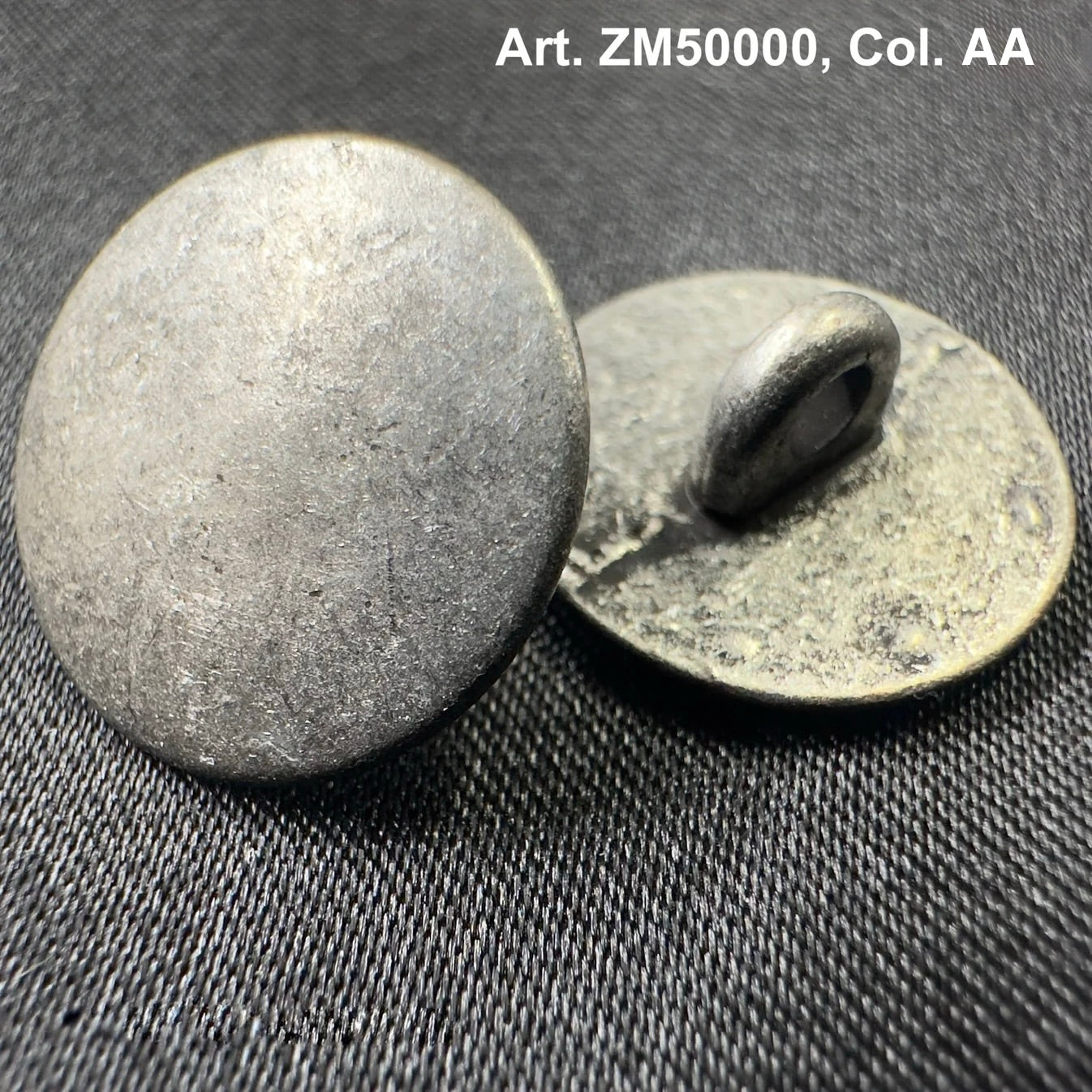 Buttonology Inc metal shank buttons with textured round design on dark fabric background