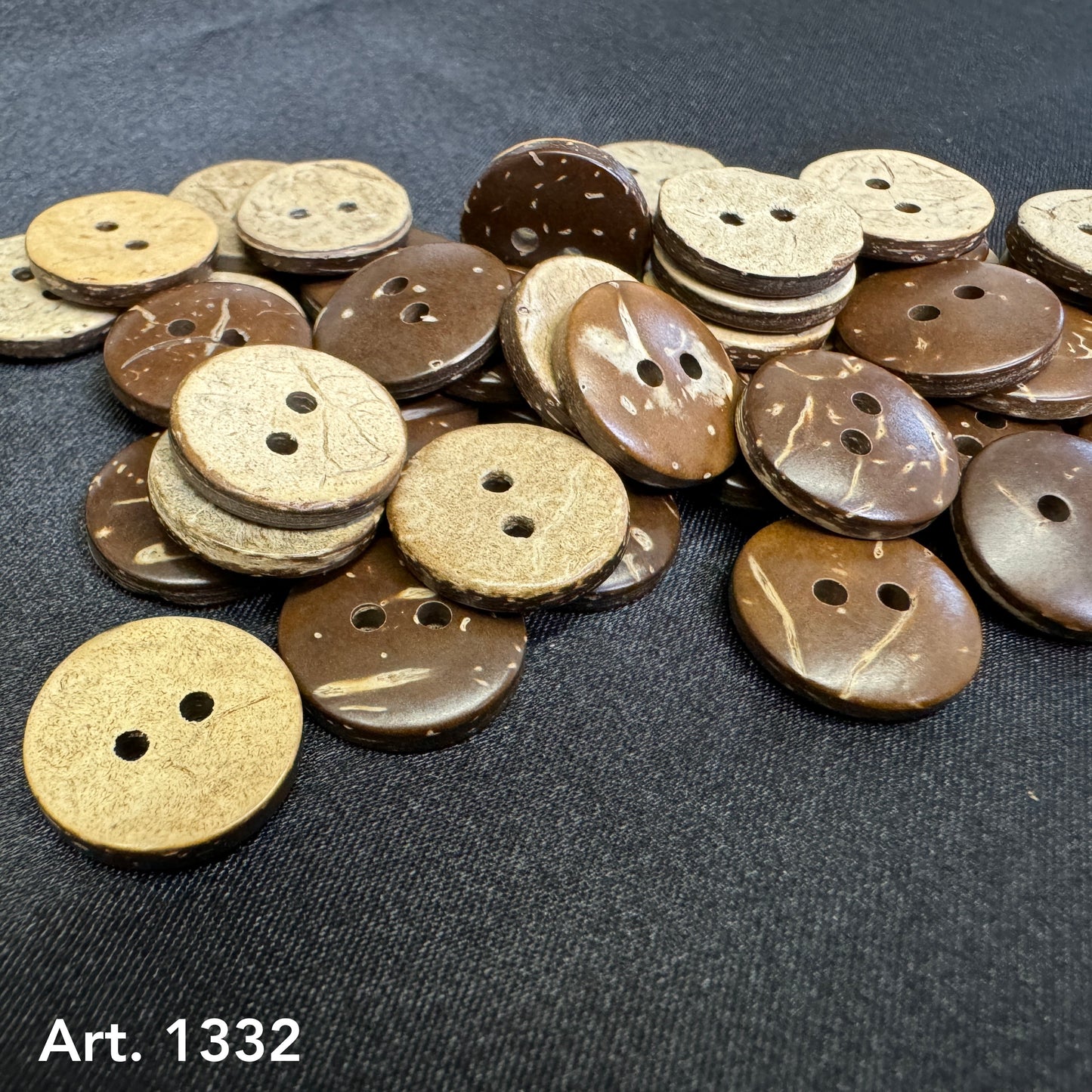 Natural coconut buttons for sewing in light and dark brown shades arranged on black fabric