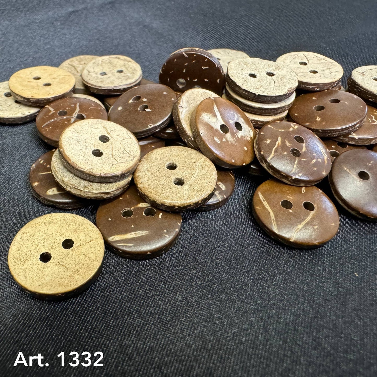 Natural coconut buttons for sewing in light and dark brown shades arranged on black fabric