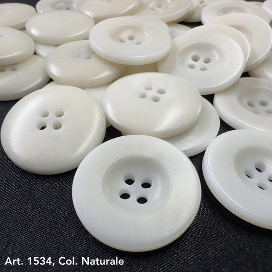 White natural corozo buttons with four holes in assorted sizes from Buttonology Inc