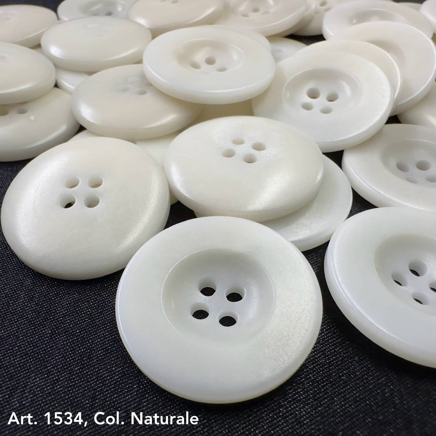 White natural corozo buttons with four holes in assorted sizes from Buttonology Inc