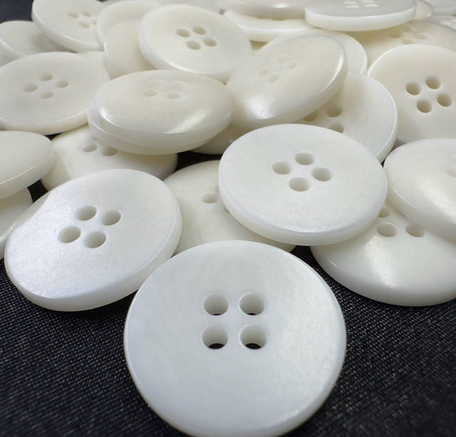 White round buttons from Buttonology Inc, an example of sustainable clothing accessories for eco-friendly fashion