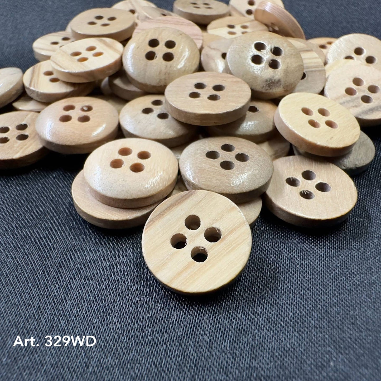 Natural wood buttons for clothes by Buttonology Inc in a pile showing smooth round shapes with four holes