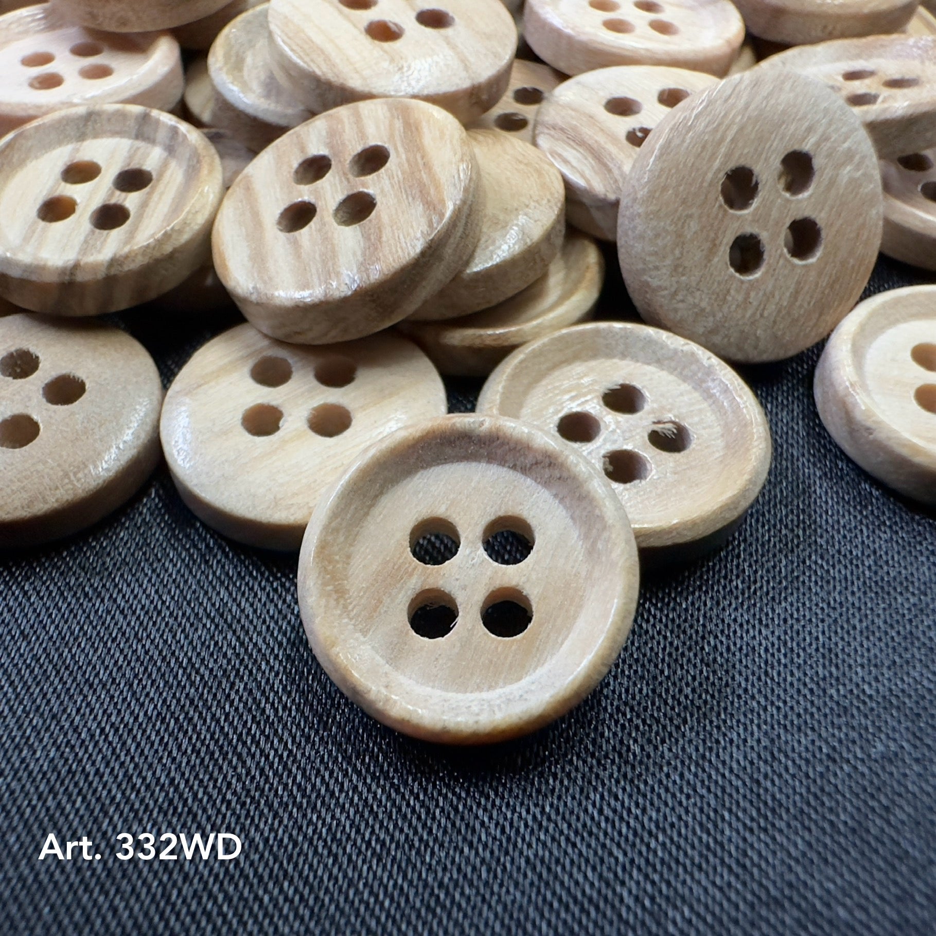 Natural wood buttons wholesale by Buttonology Inc with four holes on black fabric background