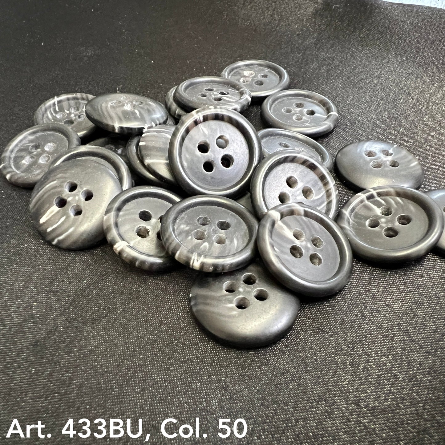 Collection of premium 4-hole sewing buttons in grey with a smooth finish, ideal for garment making